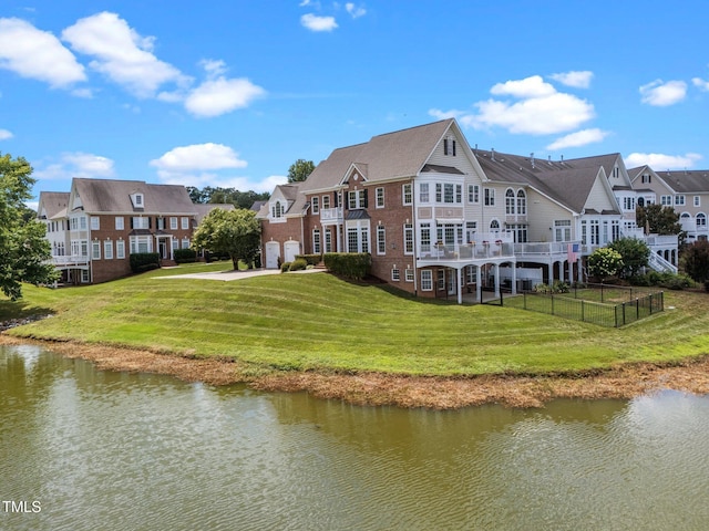12510 Megan Hill Ct, Raleigh, NC 27614 - back of house with a water view, a garage, driveway, and brick siding