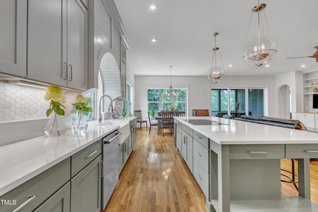 2203 Meadowcreek Dr, Durham, NC 27705 - kitchen featuring dishwasher, black electric cooktop, gray cabinetry, light countertops, and light wood-type flooring
