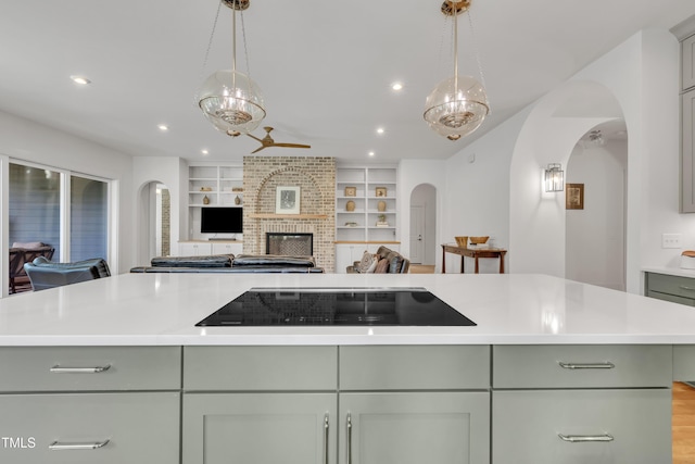 2203 Meadowcreek Dr, Durham, NC 27705 - kitchen featuring black electric stovetop, arched walkways, open floor plan, a fireplace, and recessed lighting