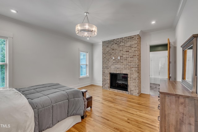 2203 Meadowcreek Dr, Durham, NC 27705 - bedroom featuring ornamental molding, light wood-type flooring, a chandelier, recessed lighting, and a fireplace