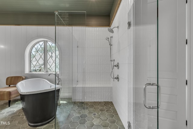 2203 Meadowcreek Dr, Durham, NC 27705 - bathroom featuring a shower stall, a freestanding bath, and tile patterned floors