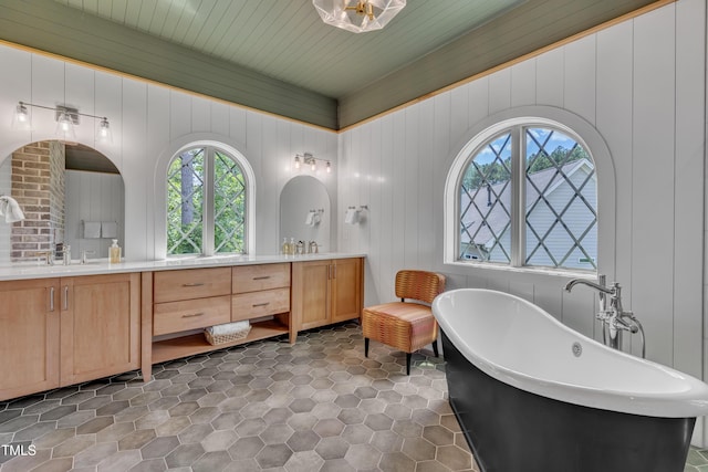 2203 Meadowcreek Dr, Durham, NC 27705 - full bath with double vanity, plenty of natural light, a freestanding tub, and tile patterned flooring