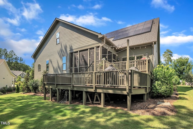 2203 Meadowcreek Dr, Durham, NC 27705 - back of property with roof with shingles, a yard, roof mounted solar panels, and a wooden deck