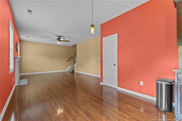 6204 Yorkie Ct, Stedman, NC 28391 - unfurnished living room featuring a ceiling fan, wood finished floors, and stairs