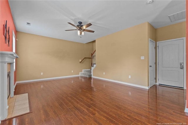 6204 Yorkie Ct, Stedman, NC 28391 - unfurnished living room featuring ceiling fan, stairway, wood finished floors, and a fireplace with flush hearth