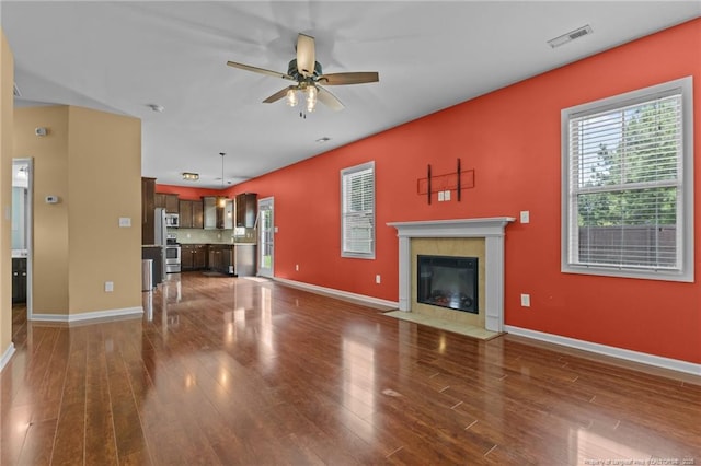 6204 Yorkie Ct, Stedman, NC 28391 - unfurnished living room with dark wood finished floors, ceiling fan, and a fireplace