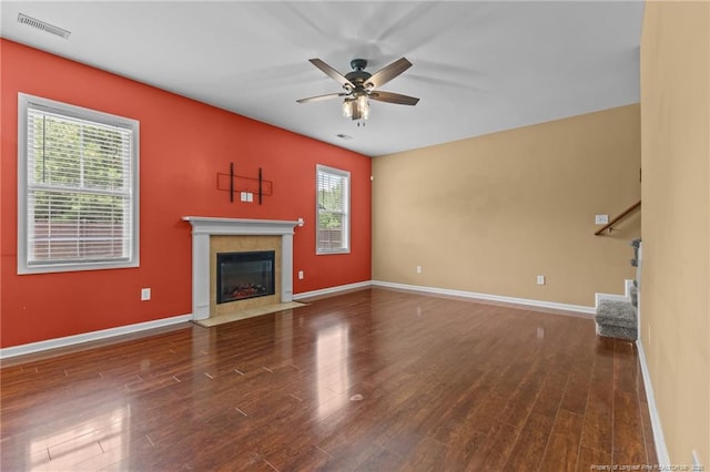 6204 Yorkie Ct, Stedman, NC 28391 - unfurnished living room featuring plenty of natural light, a ceiling fan, wood finished floors, and a fireplace with flush hearth