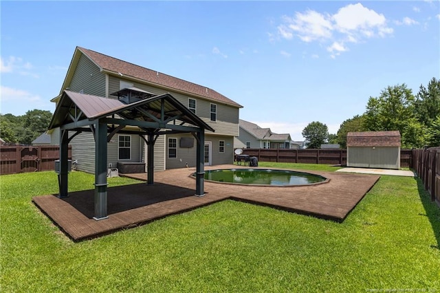 6204 Yorkie Ct, Stedman, NC 28391 - back of house featuring a gazebo, a storage unit, and a fenced backyard