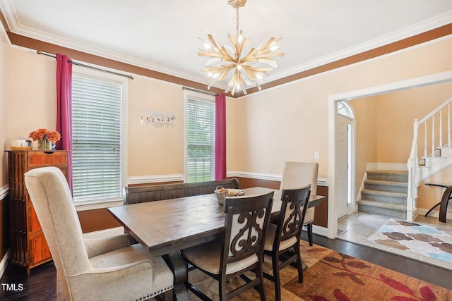 683 Castleberry Rd, Clayton, NC 27527 - dining room featuring a chandelier, stairs, crown molding, and wood finished floors