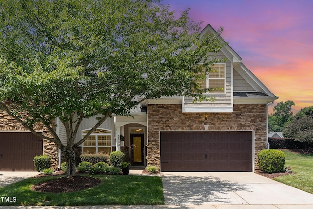 5030 Homeplace Dr, Apex, NC 27539 - view of front facade featuring stone siding, driveway, an attached garage, and a yard