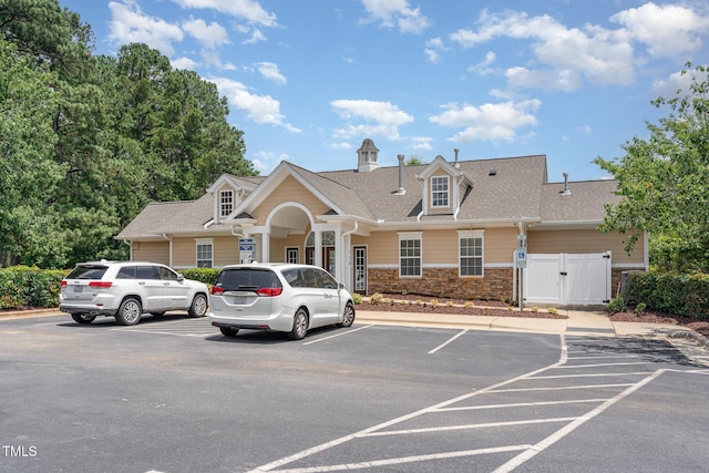5030 Homeplace Dr, Apex, NC 27539 - view of front of home featuring a gate, uncovered parking, stone siding, and a shingled roof