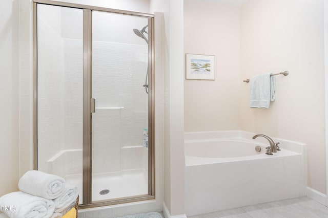 5030 Homeplace Dr, Apex, NC 27539 - bathroom with a stall shower, a garden tub, and tile patterned flooring