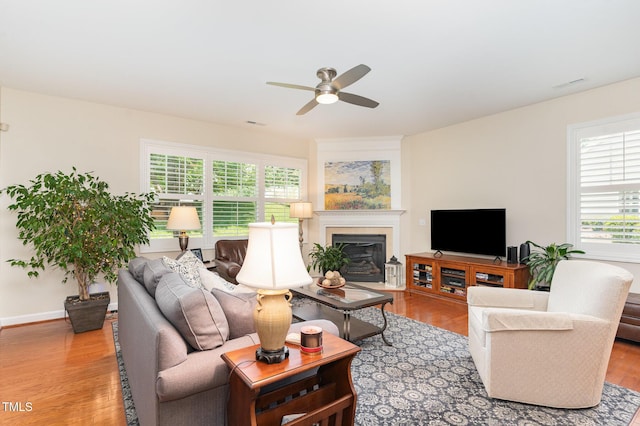 5030 Homeplace Dr, Apex, NC 27539 - living room with ceiling fan, a glass covered fireplace, and wood finished floors