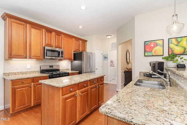 5030 Homeplace Dr, Apex, NC 27539 - kitchen featuring appliances with stainless steel finishes, light wood-type flooring, light stone counters, and recessed lighting