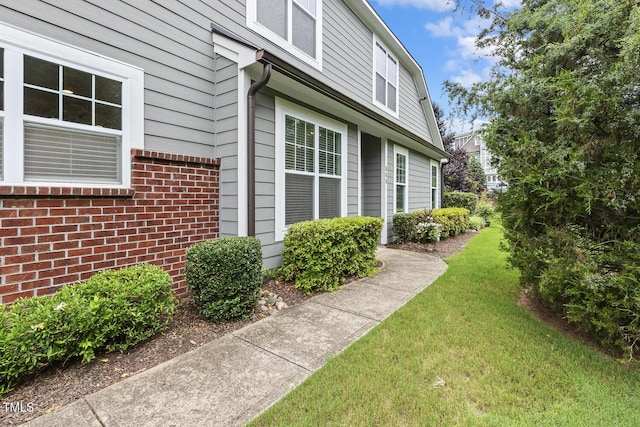 669 Fallon Grove Way, Raleigh, NC 27608 - view of side of property featuring a lawn and brick siding