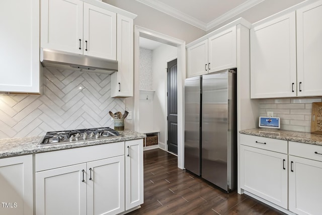 669 Fallon Grove Way, Raleigh, NC 27608 - kitchen with appliances with stainless steel finishes, under cabinet range hood, white cabinets, crown molding, and dark wood-type flooring