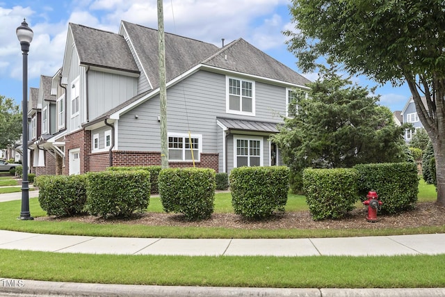 669 Fallon Grove Way, Raleigh, NC 27608 - view of property exterior with brick siding and a shingled roof