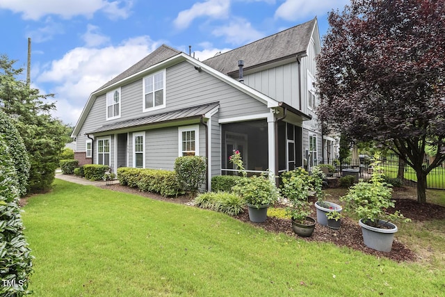 669 Fallon Grove Way, Raleigh, NC 27608 - back of property featuring a standing seam roof, roof with shingles, a sunroom, and a metal roof