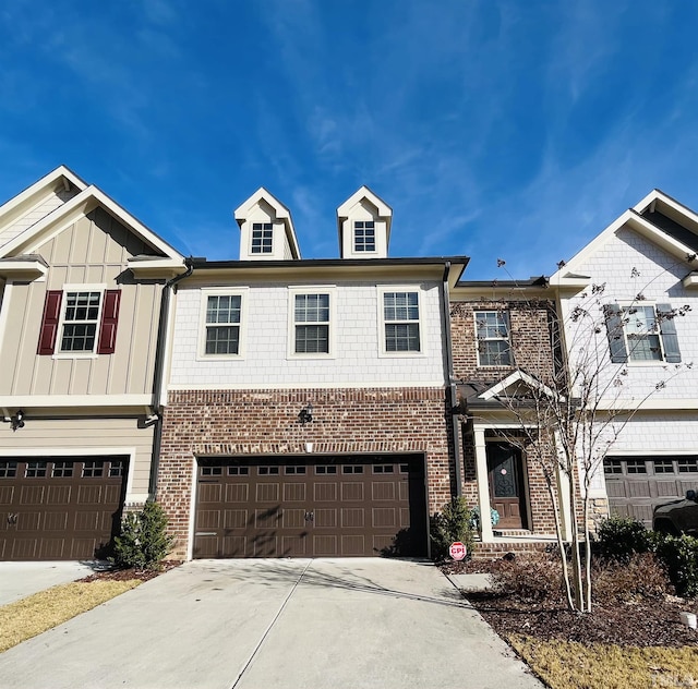 1869 Blue Jay Pt, Apex, NC 27502 - view of property featuring driveway, an attached garage, brick siding, and board and batten siding