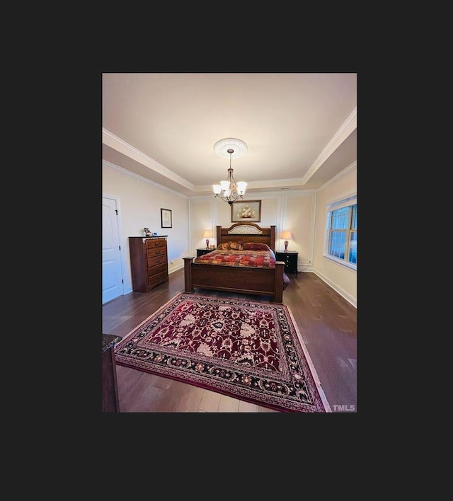 1869 Blue Jay Pt, Apex, NC 27502 - bedroom featuring a raised ceiling, a chandelier, wood finished floors, and ornamental molding