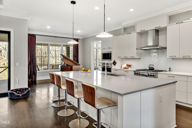 5040 Shakori Trl, Durham, NC 27707 - kitchen featuring wall chimney exhaust hood, black microwave, dark wood-style floors, ornamental molding, and decorative backsplash