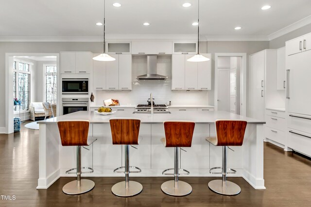 5040 Shakori Trl, Durham, NC 27707 - kitchen with wall chimney range hood, built in appliances, ornamental molding, modern cabinets, and dark wood-style floors