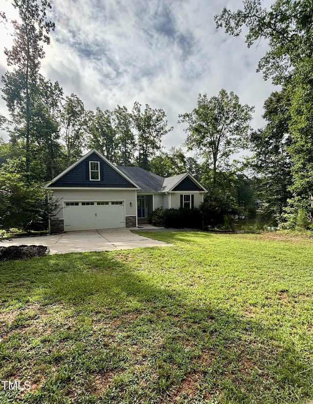 1119 Sagamore Dr, Louisburg, NC 27549 - view of front of home featuring driveway, an attached garage, a front yard, and stone siding