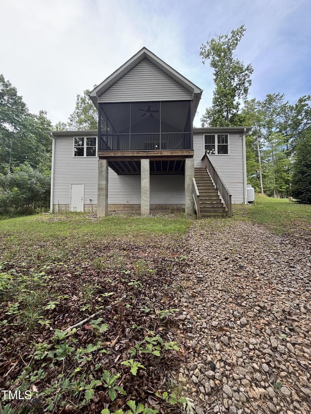 1119 Sagamore Dr, Louisburg, NC 27549 - back of property with a sunroom, stairs, and ceiling fan