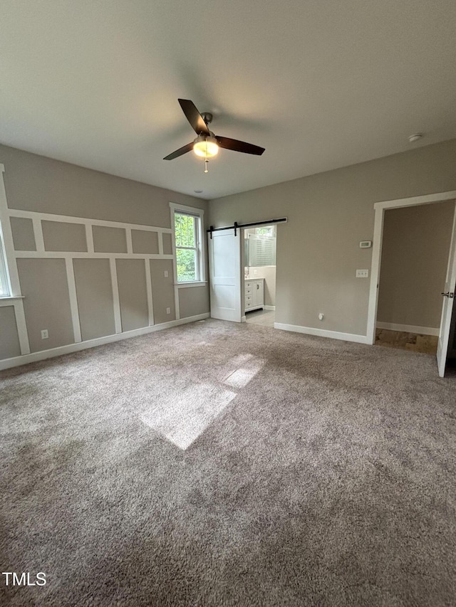 1119 Sagamore Dr, Louisburg, NC 27549 - unfurnished bedroom with carpet flooring and a barn door