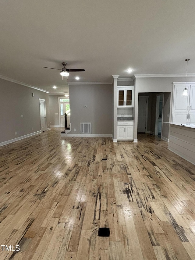 1119 Sagamore Dr, Louisburg, NC 27549 - unfurnished living room featuring light wood-style floors, crown molding, a ceiling fan, and recessed lighting