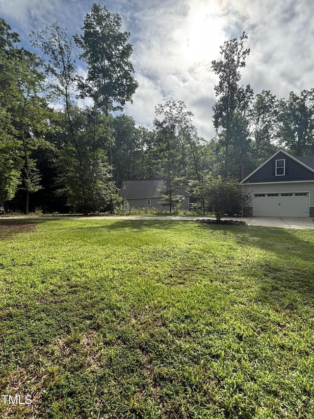 1119 Sagamore Dr, Louisburg, NC 27549 - view of green lawn with an attached garage