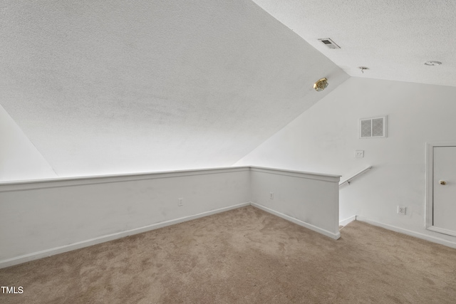 241 Commons Dr, Holly Springs, NC 27540 - carpeted spare room featuring vaulted ceiling and a textured ceiling
