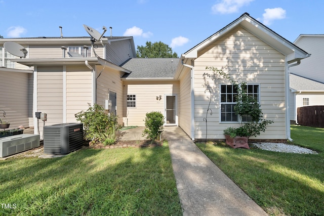 241 Commons Dr, Holly Springs, NC 27540 - view of front facade featuring a front yard, a patio area, and a shingled roof