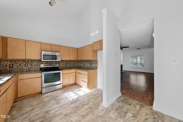 241 Commons Dr, Holly Springs, NC 27540 - kitchen with stainless steel appliances, backsplash, a ceiling fan, a high ceiling, and light brown cabinets