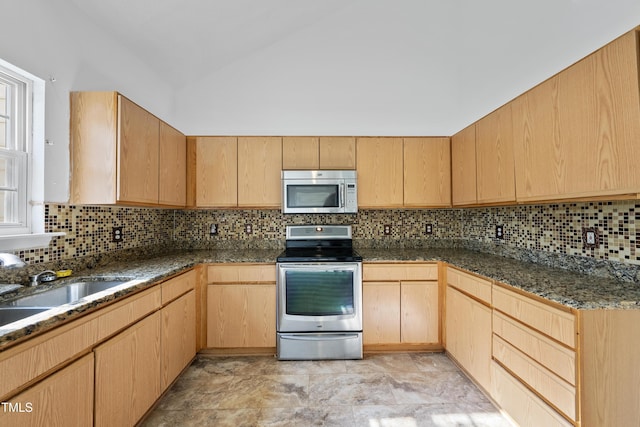 241 Commons Dr, Holly Springs, NC 27540 - kitchen featuring stainless steel appliances, light brown cabinetry, vaulted ceiling, and backsplash