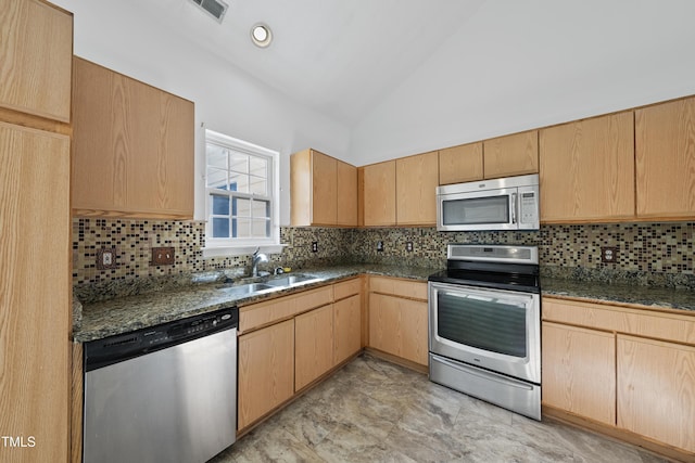 241 Commons Dr, Holly Springs, NC 27540 - kitchen with stainless steel appliances, light brown cabinetry, lofted ceiling, and decorative backsplash