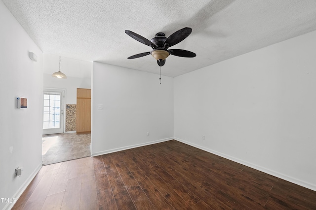 241 Commons Dr, Holly Springs, NC 27540 - empty room with a ceiling fan, dark wood-type flooring, and a textured ceiling