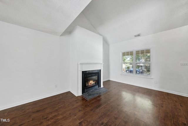 241 Commons Dr, Holly Springs, NC 27540 - unfurnished living room featuring a fireplace with flush hearth, vaulted ceiling, and dark wood finished floors
