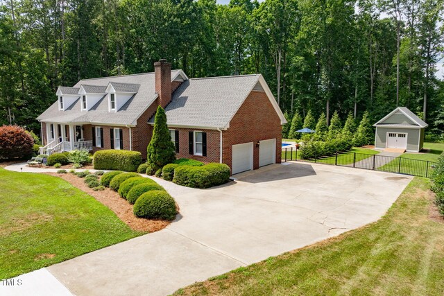 4135 Somerset Dr, Oxford, NC 27565 - view of front facade featuring brick siding, a chimney, a porch, and driveway