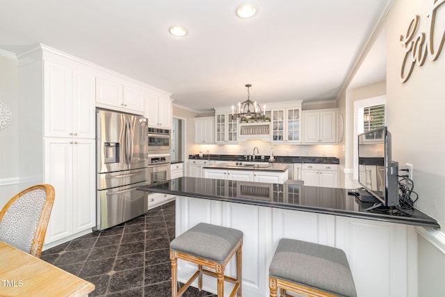 4135 Somerset Dr, Oxford, NC 27565 - kitchen featuring stainless steel appliances, dark countertops, a peninsula, a chandelier, and white cabinetry