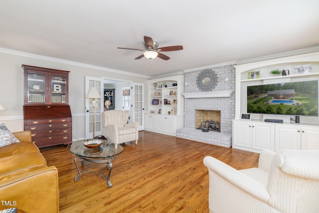 4135 Somerset Dr, Oxford, NC 27565 - living room with ceiling fan, light wood-style flooring, a brick fireplace, and crown molding