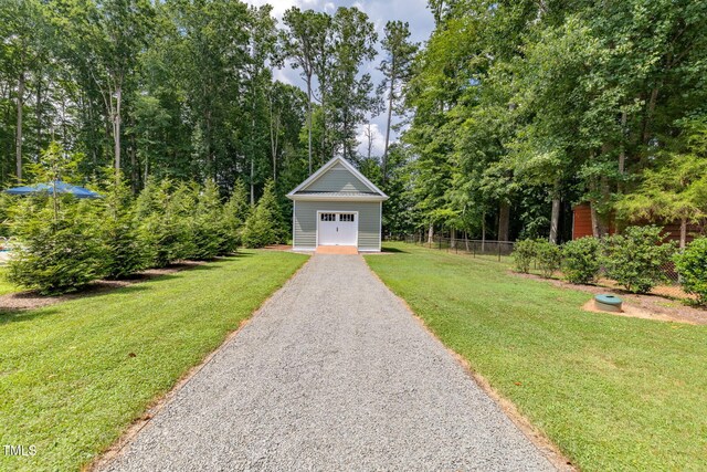 4135 Somerset Dr, Oxford, NC 27565 - view of yard featuring a garage, driveway, and an outdoor structure