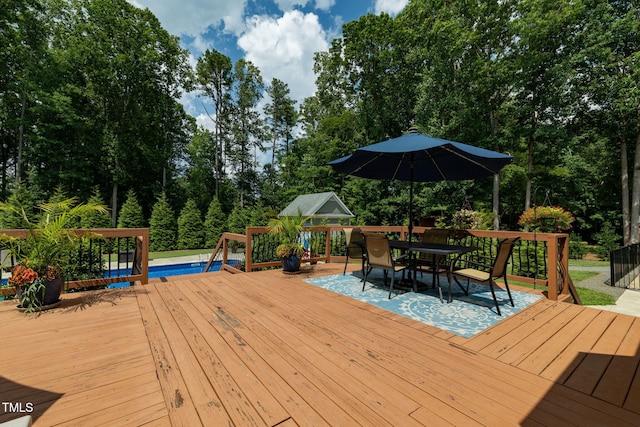 4135 Somerset Dr, Oxford, NC 27565 - deck with outdoor dining space, view of scattered trees, and an outdoor pool
