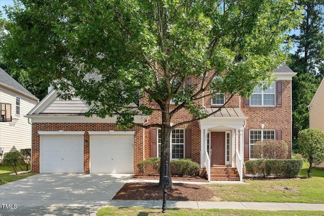 2021 Patapsco Dr, Apex, NC 27523 - view of front facade featuring an attached garage, concrete driveway, brick siding, and a standing seam roof