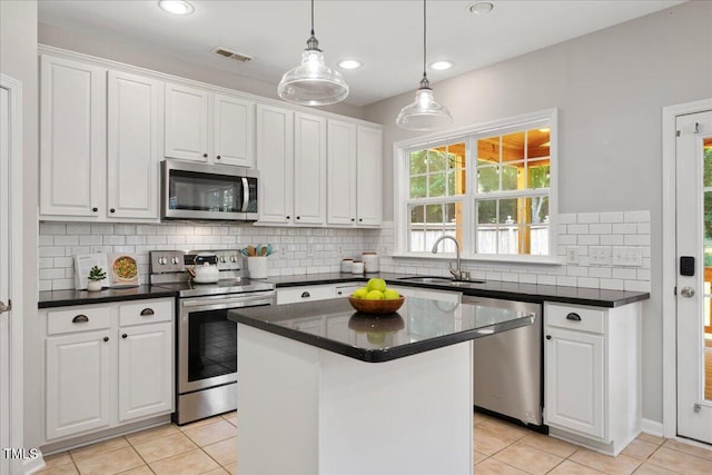 2021 Patapsco Dr, Apex, NC 27523 - kitchen featuring stainless steel appliances, white cabinets, light tile patterned flooring, decorative backsplash, and recessed lighting