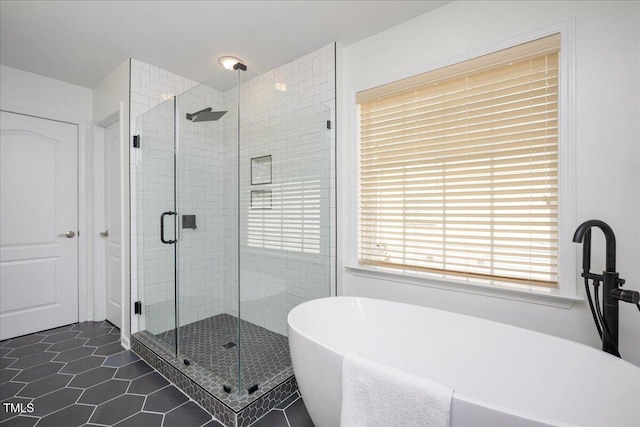 2021 Patapsco Dr, Apex, NC 27523 - bathroom featuring a freestanding bath, a shower stall, and tile patterned flooring