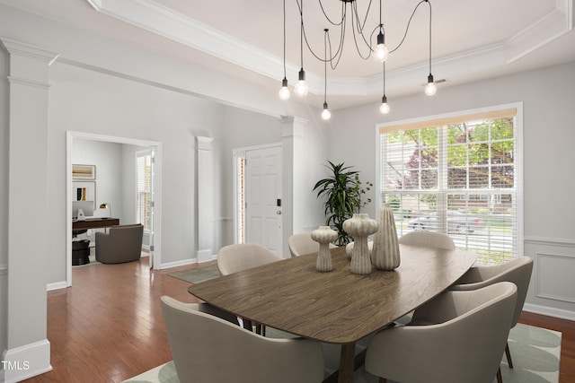 2021 Patapsco Dr, Apex, NC 27523 - dining area featuring ornate columns, a raised ceiling, ornamental molding, wood finished floors, and a chandelier
