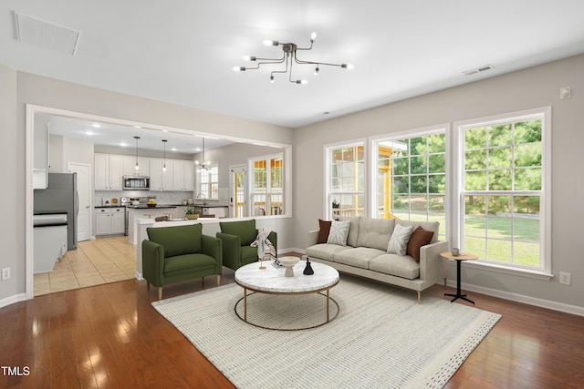 2021 Patapsco Dr, Apex, NC 27523 - living area featuring a chandelier, healthy amount of natural light, light wood-type flooring, and recessed lighting