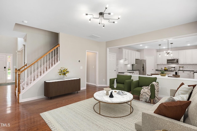 2021 Patapsco Dr, Apex, NC 27523 - living area featuring a chandelier, wood finished floors, stairs, and recessed lighting