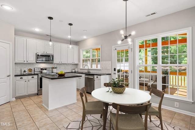 2021 Patapsco Dr, Apex, NC 27523 - kitchen with appliances with stainless steel finishes, backsplash, dark countertops, white cabinets, and recessed lighting